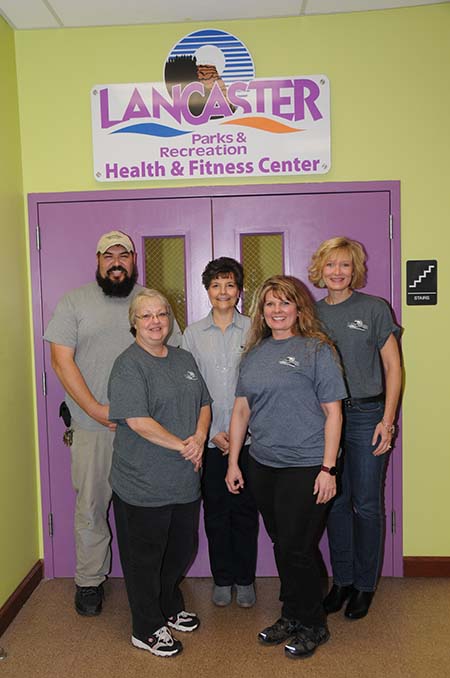 staff standing in front of office door